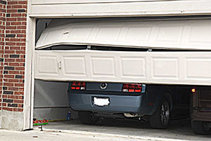 picture of garage door crashed on top of car